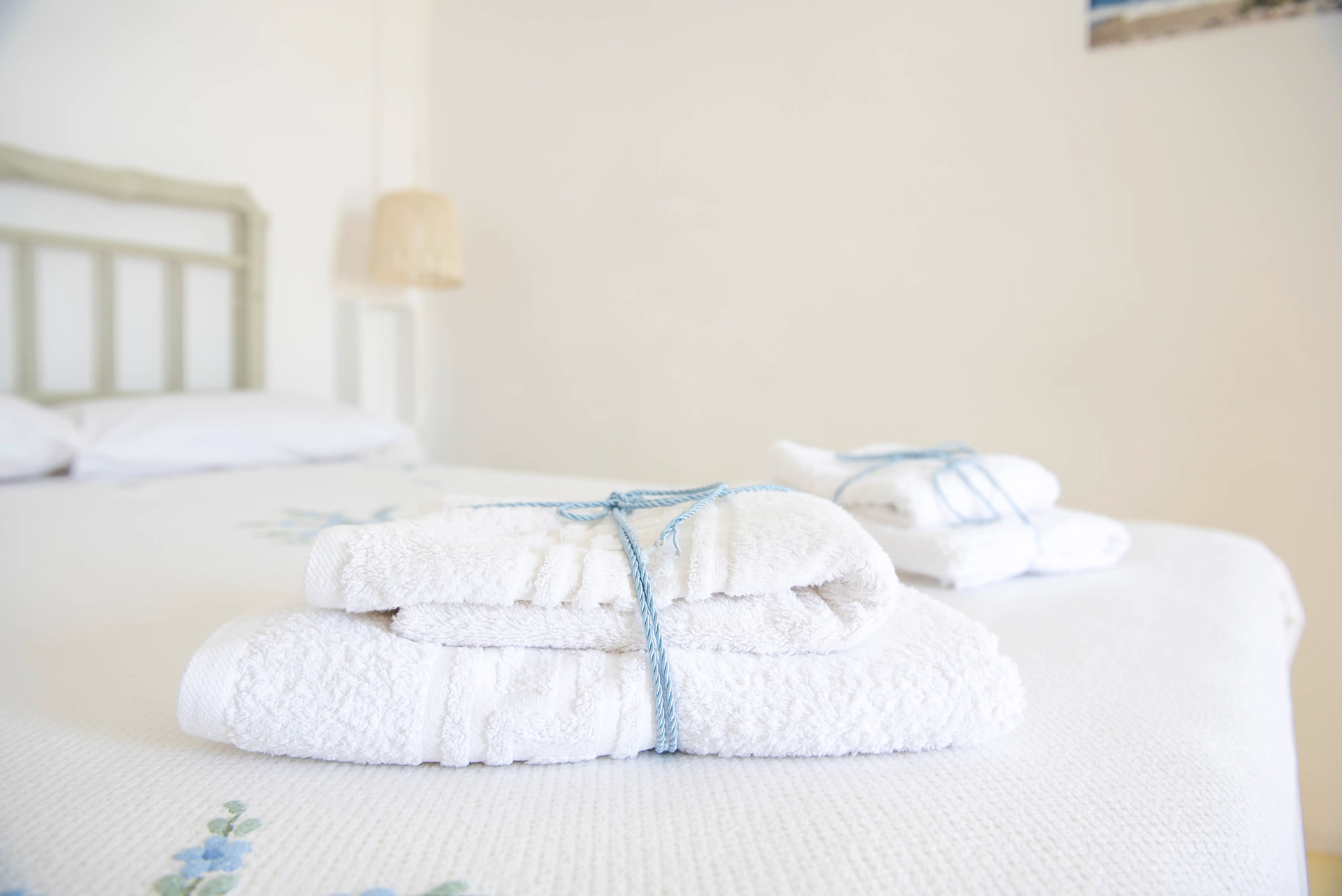 Fresh white towels tied with blue ribbon, The Studio